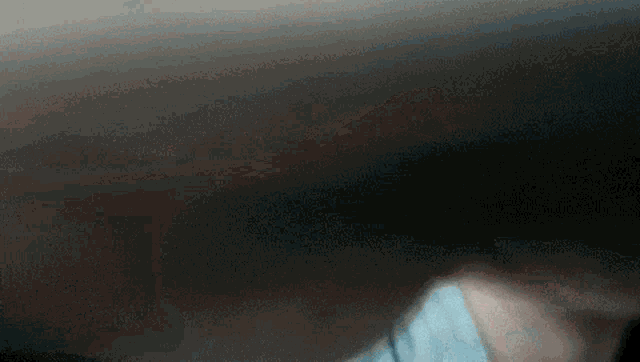 a blurred image of a person 's face with a dark background