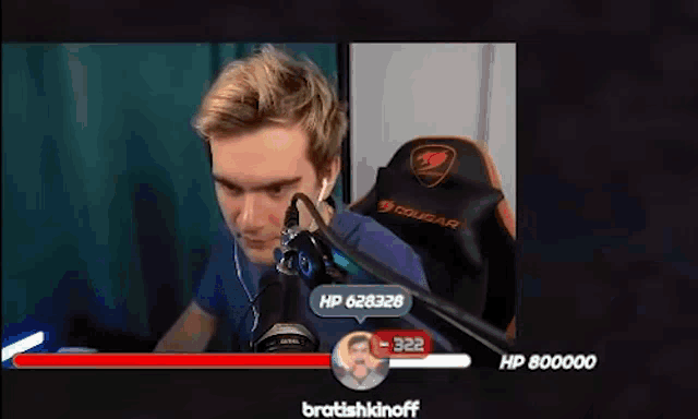 a man is sitting in a chair talking into a microphone while wearing headphones .