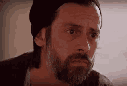 a man with a beard is wearing a beanie
