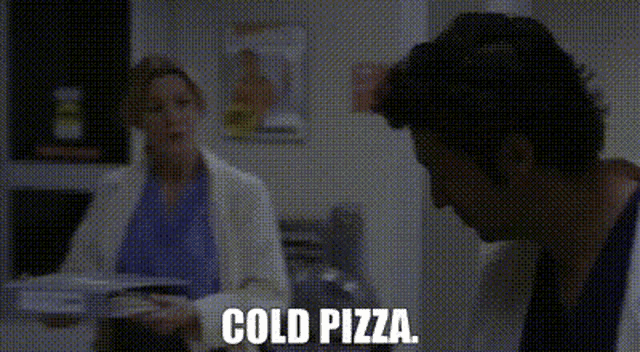 a man in a lab coat is sitting at a table with a stack of pizzas and says `` cold pizza '' .