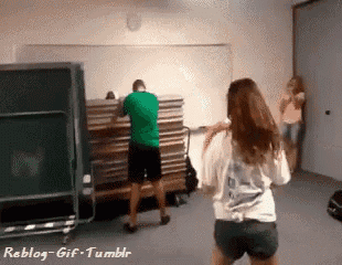 a man in a green shirt is standing next to a woman in a white shirt with the word reblog on it