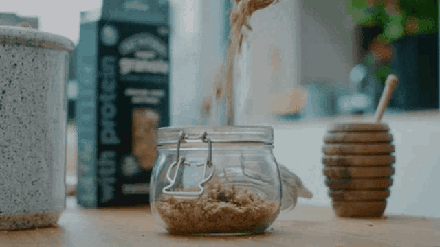 a jar of oatmeal is sitting on a counter next to a box of protein oatmeal