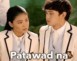 a man and a woman in school uniforms are looking at each other and the words patawad na are above them .