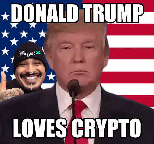 donald trump giving a speech in front of an american flag with a man wearing a beanie that says likezzard