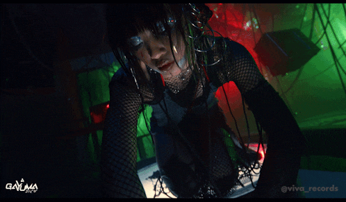 a woman in fishnet stockings is kneeling down in front of a sign that says gayima