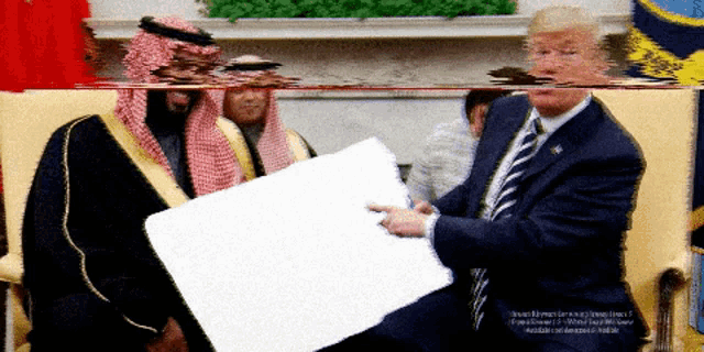 a man in a keffiyeh holds a white board in front of donald trump