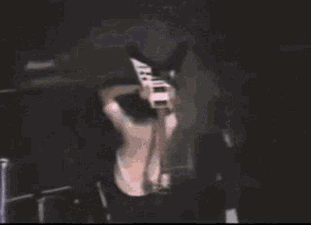 a blurry picture of a man on stage with the word music on the bottom left