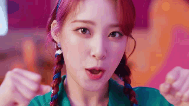a close up of a woman with red hair and braids