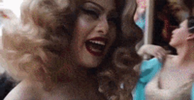 a close up of a drag queen with her mouth open