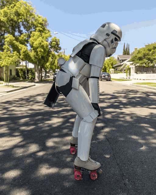 a storm trooper rollerblading down a street with red wheels