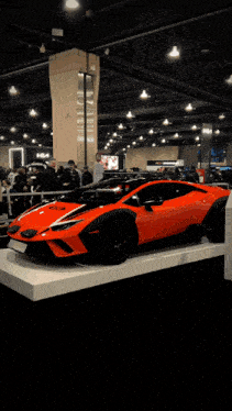 a red lamborghini huracan is on display in a car show