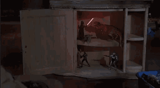 a wooden cabinet with a t-rex and a storm trooper inside