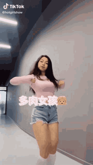 a woman is dancing in a hallway with a tiktok watermark