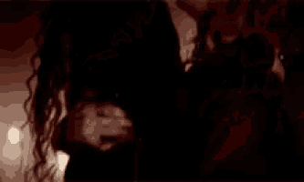 a woman is laying on her back with her head on a man 's shoulder .