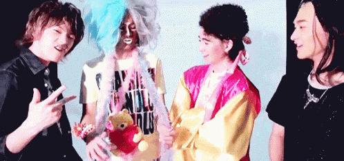 a group of people standing next to each other with one wearing a winnie the pooh teddy bear .