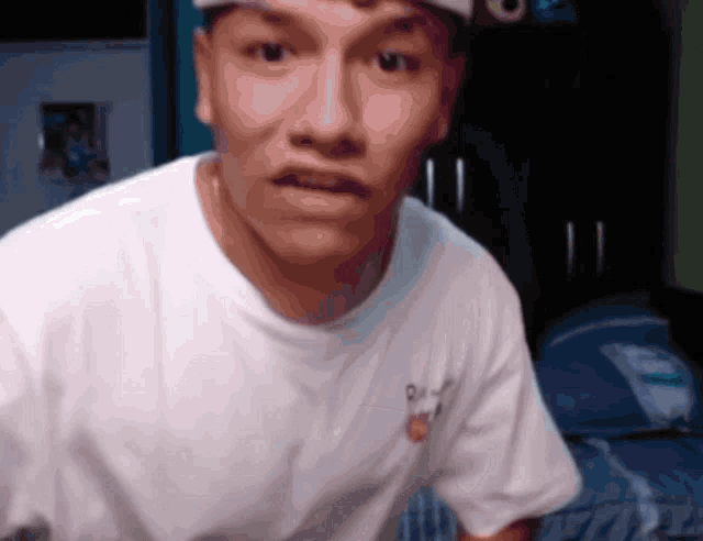 a young man wearing a white t-shirt with a chicago bulls logo