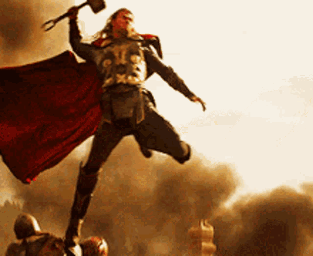 a man in a cape is holding a hammer