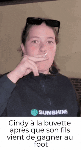 a woman smoking a cigarette wearing a sunshine jacket