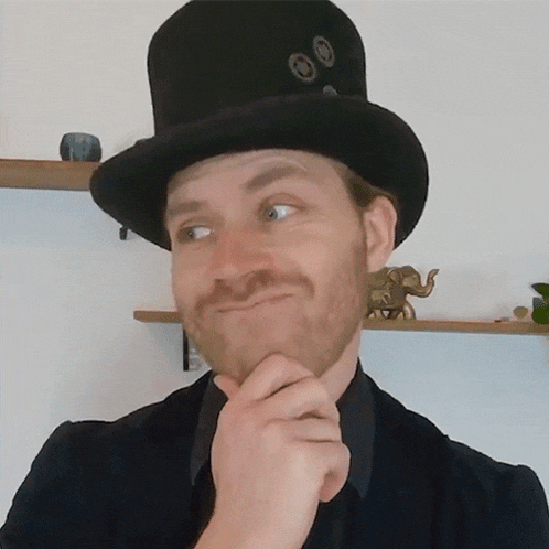a man wearing a top hat is making a face