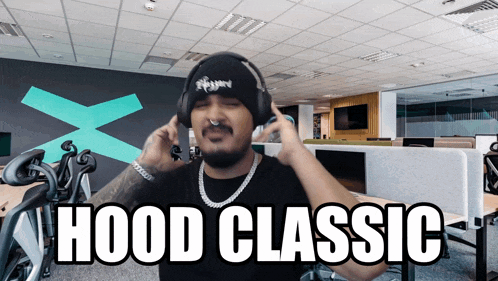 a man wearing headphones and a beanie with the words hood classic on it