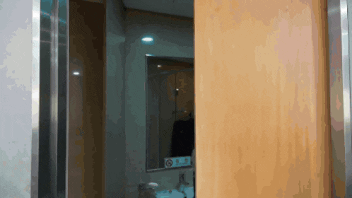 a bathroom with a no smoking sign on the mirror