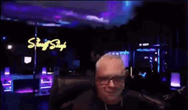 a man is sitting in front of a sign that says strip shack