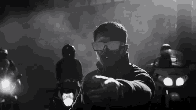a man wearing sunglasses is pointing at something