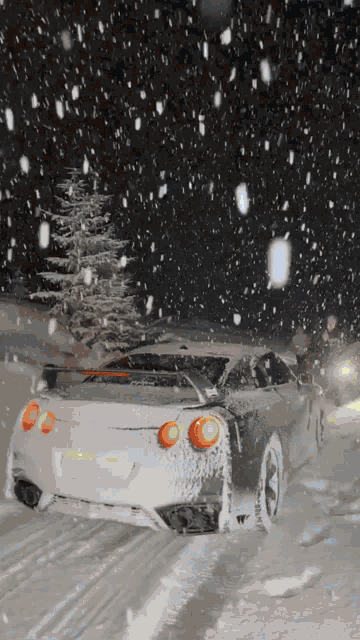 a car is driving through a snowy area with a california license plate
