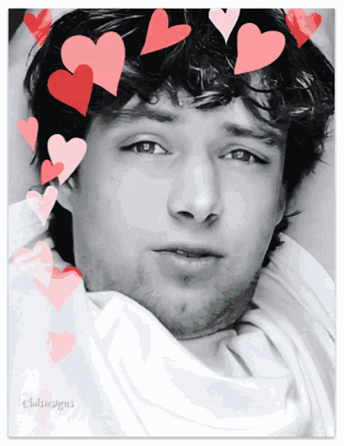 a black and white photo of a young man with hearts on his hair