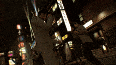 a man in a white jacket kicks another man in a red shirt in a video game
