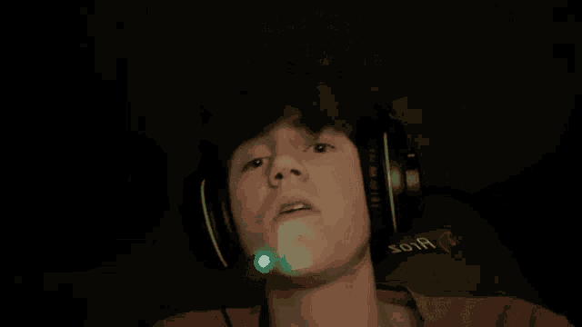 a close up of a person 's face with headphones
