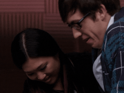 a man and a woman are looking at each other