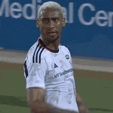 a soccer player wearing a white shirt that says southwest mercantile