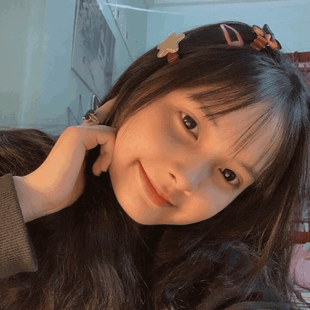 a girl with a star shaped hair clip on her hair