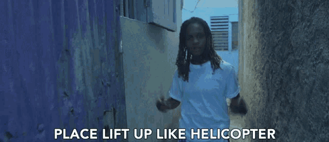 a man in a white shirt is standing in a narrow alleyway with the words place lift up like helicopter behind him