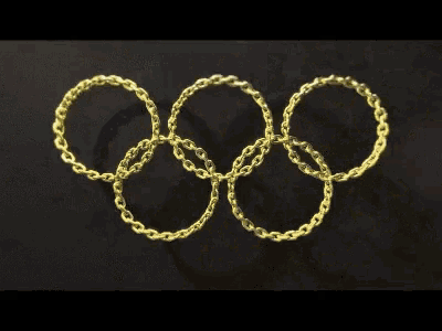 a bullet is breaking through the olympic rings made of chains