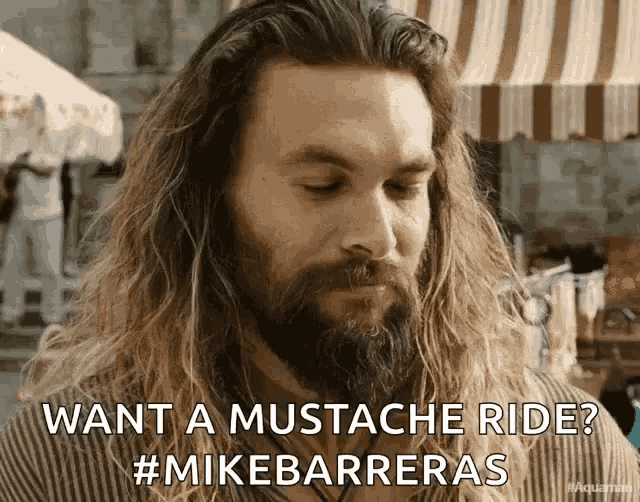a man with long hair and a beard asks " want a mustache ride "