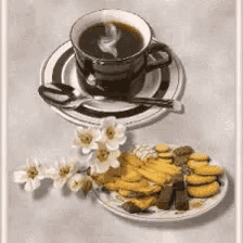a cup of coffee sits on a saucer next to a plate of cookies and flowers