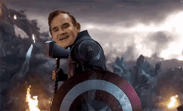 a man in a captain america costume is holding a hammer and shield