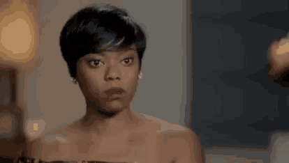 a woman in a dress is making a funny face and looking at the camera .