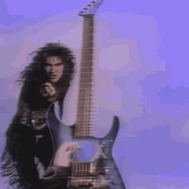 a woman is dancing in front of a guitar in a blurry picture .