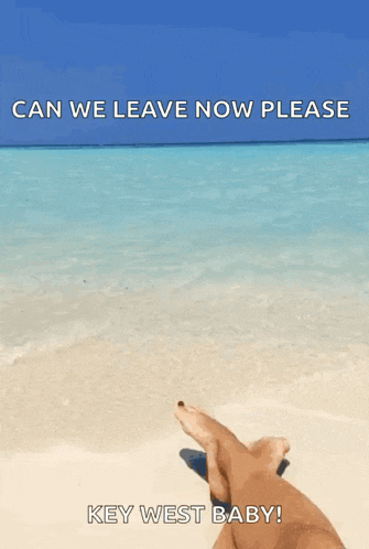 a person laying on a beach with a caption that says key west baby