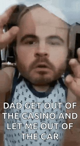 a man with a beard is talking on a cell phone while wearing a bandage on his head .