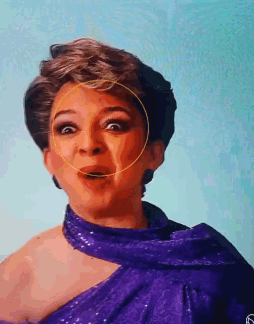 a woman wearing a purple dress has a yellow circle around her face