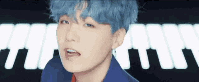 a close up of a person with blue hair .