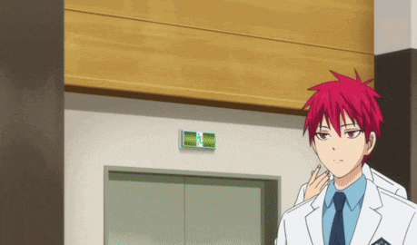 a man with red hair is standing in front of a elevator