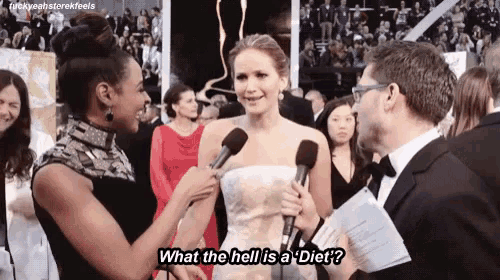 a woman in a white dress is being interviewed by a man in a tuxedo with the words what the hell is a diet