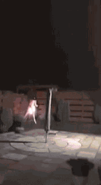 a blurred image of a person sitting on a chair in a dark room