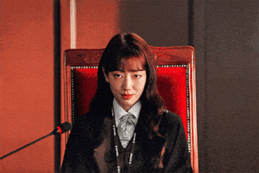a woman sitting in a red chair with a lanyard that says microsoft on it