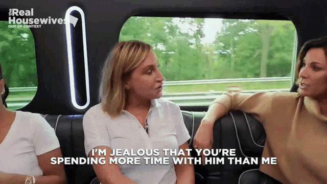 two women are sitting in a car and one says i 'm jealous that you 're spending more time with him